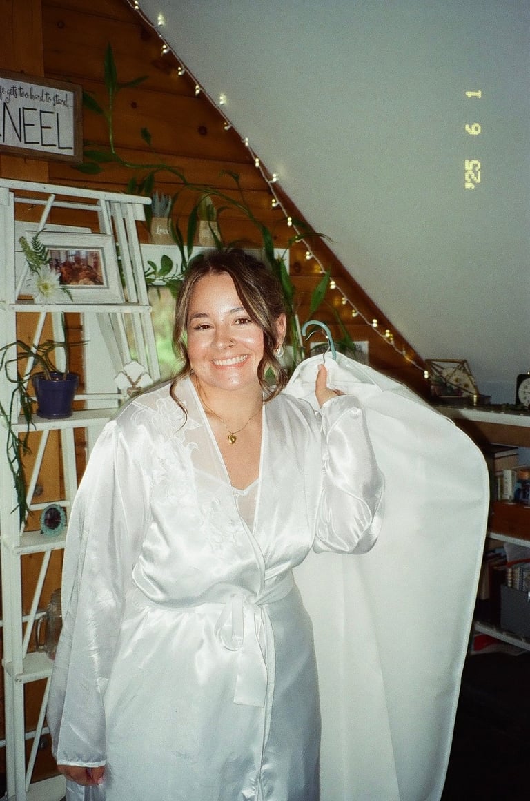 Woman wearing white shirt in cozy attic room with wooden beams, shelving, plants, and holiday decorations